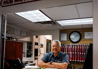 Ed in the office, under the Hub Motor Service office sign