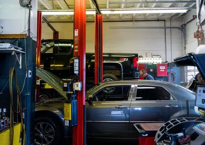 A car on a hoist in the service bay