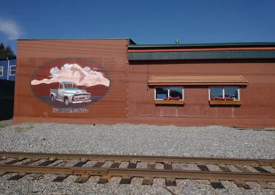 Truck mural on the side of the shop, beside the railway tracks