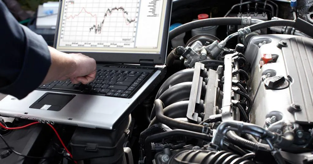 Diagnostic laptop connected to an engine
