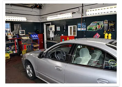 A silver car in the service bay