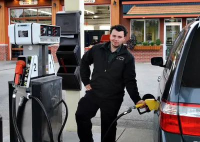 An attendant filling up a customer's car